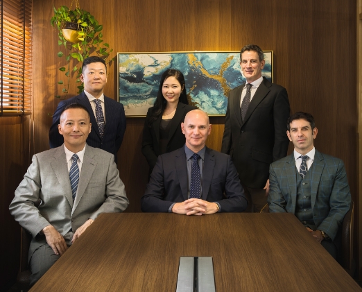 Business scene with a group of men in suits standing together.