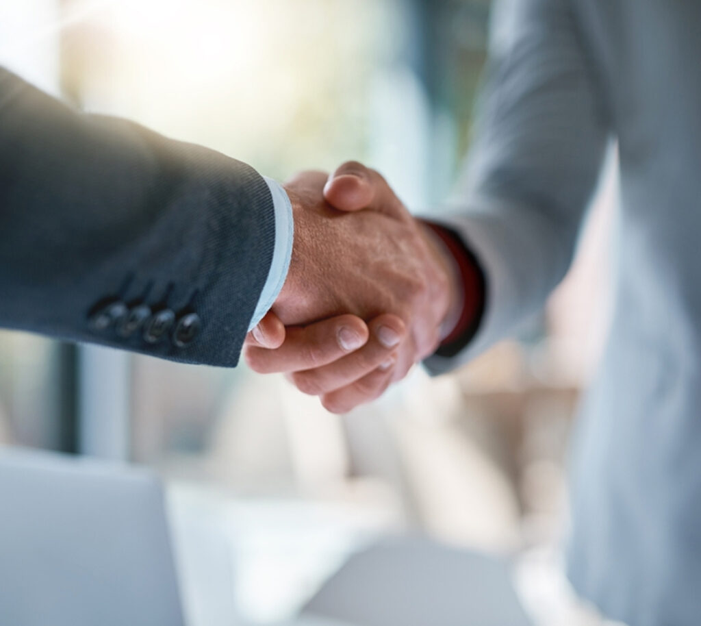 Close-up of a business handshake between two men.