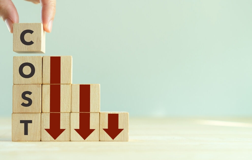 Image showing blocks spelling "COST" with arrows pointing downward, symbolizing cost reduction.